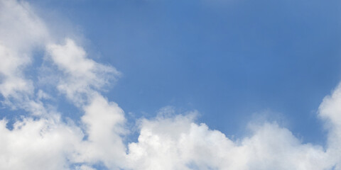 Horizontal bright blue sky with white clouds at the bottom of the background. Nature ,beautiful sky landscape in sunny day.