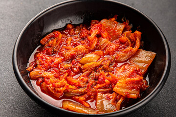 Kimchi pickled cabbage salad spicy savory vegetables fresh delicious gourmet food background on the table rustic food top view copy space vegetarian and vegan food