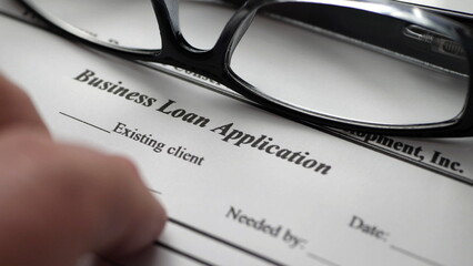 Finger tapping on business loan application