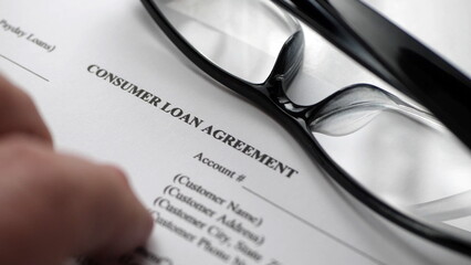 Finger tapping on consumer loan agreement