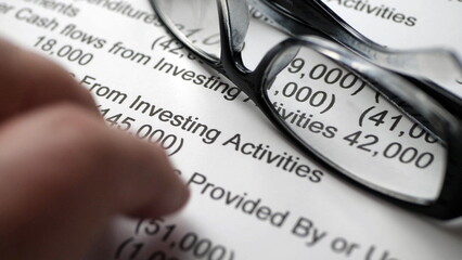 Finger tapping on financial report