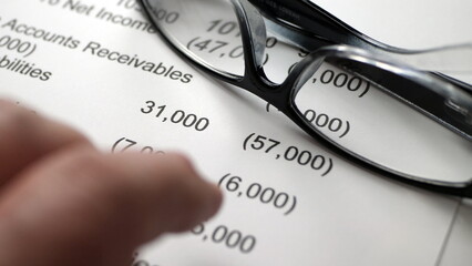 Finger tapping on financial report