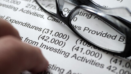 Finger tapping on financial report
