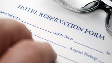 Finger tapping on hotel reservation form
