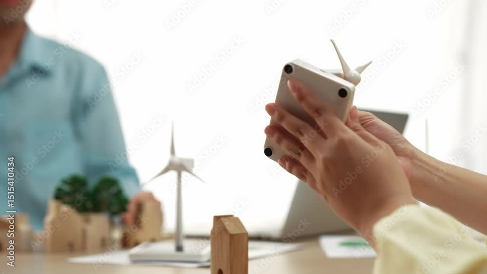 Poster windmill model represented using clean energy and wooden block symbolized ecology house. green energ