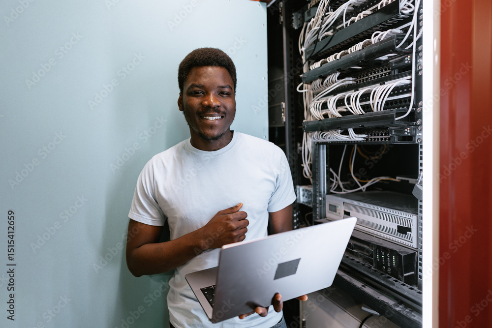 Aufkleber technician working on network cables in a data center with laptop during daytime
