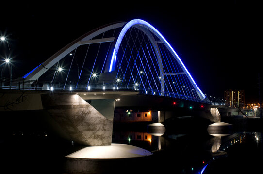 lowry avenue or county highway 153 tied-arch steel bridge spanning mississippi river connecting northeast to north minneapolis neighborhoods at night