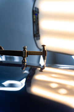Controlled taps with a knockdown tool reshape metal warped by hail. PDR technician uses a knockdown tool and hammer combo to correct hail dents. Focused strikes realign metal without harming paint.