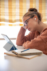 A girl student is talking on the phone at home. Conversation on the phone.