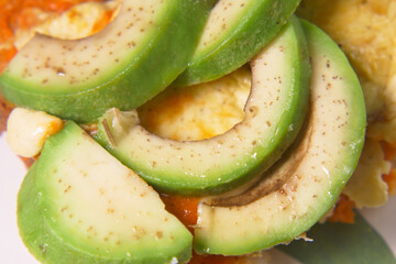 Freshly sliced avocado atop a colorful dish