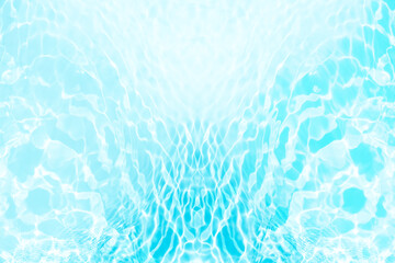 Blue water with ripples on the surface. Defocus blurred transparent blue colored clear calm water surface texture with splashes and bubbles. Water waves with shining pattern texture background.