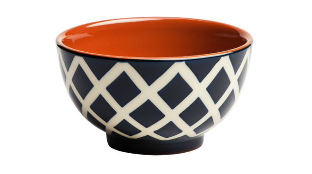 A ceramic bowl with an orange interior and navy blue geometric lattice pattern. Transparent background.