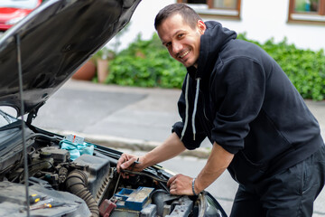 A driver replacing the car battery. Car battery repair and inspection. Repair, maintenance, ...