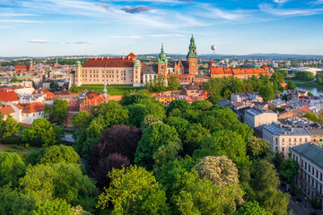 Panorama of soft lighted Wawel Castle and Planty park at spring afternoon, Old Town in Krakow, Poland