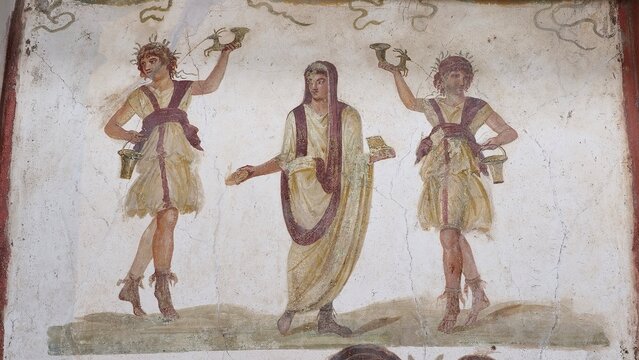 Pompeii, Italy &ndash; 8 January 2025: Close-up of the lararium fresco in the House of the Vettii showing the household gods (Lares) and a central genius figure offering libations in ceremonial dress.