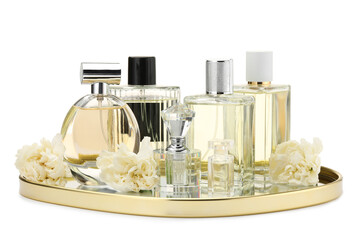 Many different perfume bottles and flowers isolated on white