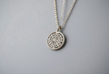 silver necklace with a medallion on a chain
