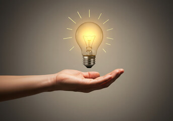 Hand holding light bulb idea concept innovation inspiration creativity solution brainstorming power energy 100w