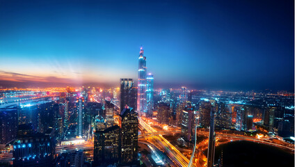 Fototapeta premium Brightly Lit Cityscape at Dusk Showcasing Modern Architecture and Skyline