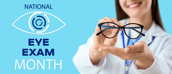 Beautiful young happy female ophthalmologist with new eyeglasses on blue background, closeup