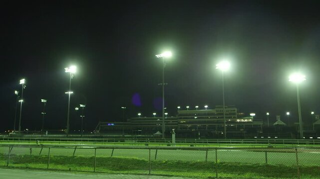 Racetrack stadium lights turning on in the morning