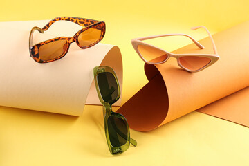 Plakat Stylish sunglasses on color background