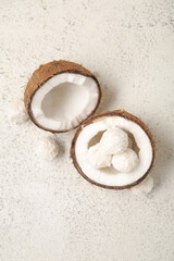 Coconut with white chocolate candies on light table