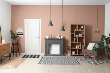 Obraz premium Interior of modern living room with fireplace, shelving unit and armchair