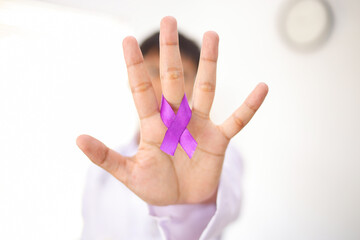 Doctor Holding Purple Cancer Awareness Ribbon.
