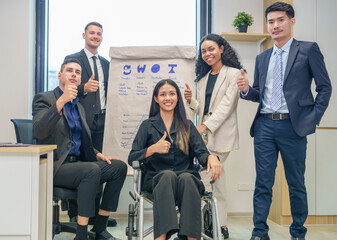 corporate diverse business people and business person with disability meeting, discussing,analysis new business strategy by using flipchart in boardroom