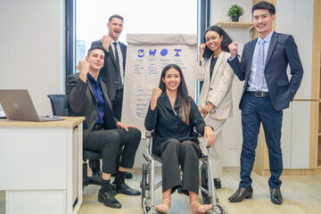 corporate diverse business people and business person with disability meeting, discussing,analysis new business strategy by using flipchart in boardroom