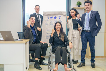corporate diverse business people and business person with disability meeting, discussing,analysis new business strategy by using flipchart in boardroom