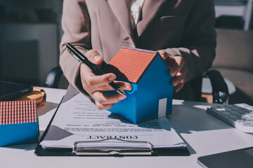 Female Real Estate Broker presenting and advised to .model home and building project detail in the...