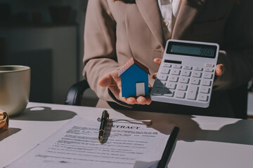 Female Real Estate Broker presenting and advised to .model home and building project detail in the...