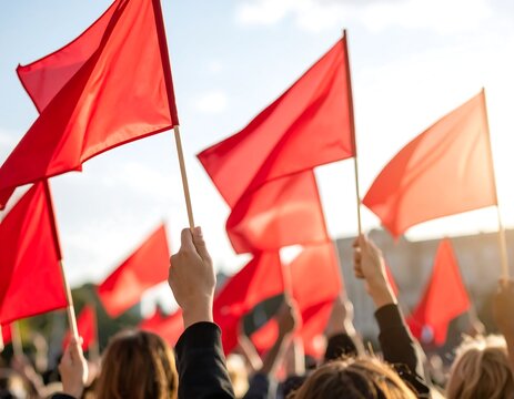Red flags held high in a crowd