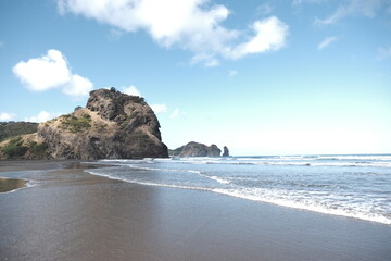 Black sand beach with waves crashing 