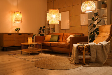 Interior of stylish living room with brown sofa, coffee table and glowing lamps at evening