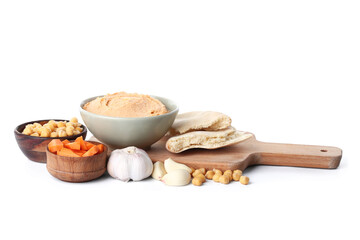 Bowl of tasty hummus with carrot, garlic and chickpeas on white background