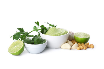 Bowl of tasty peas hummus with lime, parsley, spinach and garlic on white background