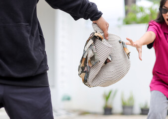 Woman Shocked as Her Bag is Stolen by Black-dressed Man in Public Area.