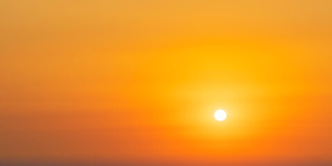 Spectacular sunrise on the horizon with the sea at your feet. Romantic sunrise. Beach sunrises. The sun tries to rise through the clouds in the orange sunrise. Travel and landscape concept.