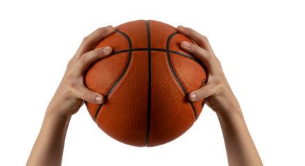 A pair of hands gripping a basketball, poised for a shot, with a blurred sports court background suggesting an intense game