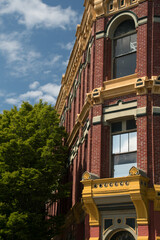 Rich exterior details of red Victorian building in Port Townsend downtown - 3