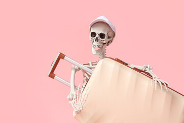 Human skeleton with suitcase on pink background. Travel concept