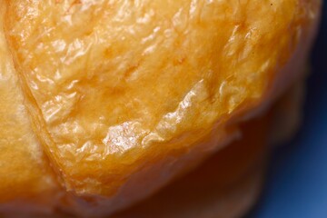 Croissant placed on a white napkin in a cozy cafe setting.