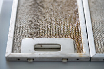 Dirty oily metal exhaust filter not cleaned for long time. Kitchen hood clogged filter needs...