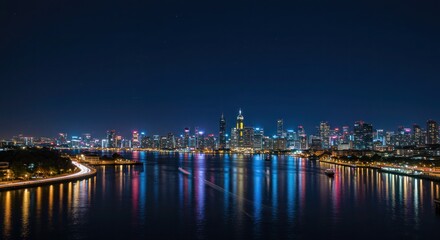 Obraz premium Shimmering cityscape at night reflecting off water