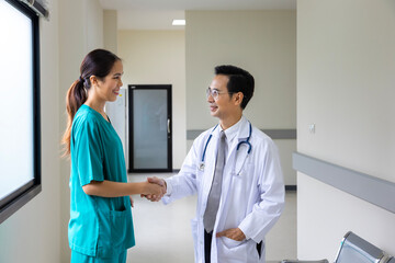 Team of Asian doctor and nurse is handshaking after working on patient medical record for precise care plan with experienced senior physician specialist