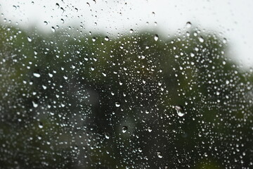 water drop on mirror in rainy day, blur natural background
