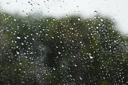 water drop on mirror in rainy day, blur natural background